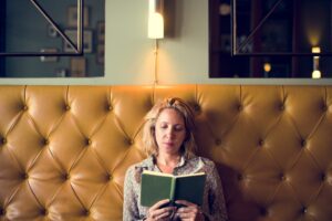 Blond woman reading a book