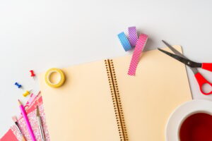 Creative workspace setup features colorful supplies and notebook for DIY projects in a bright