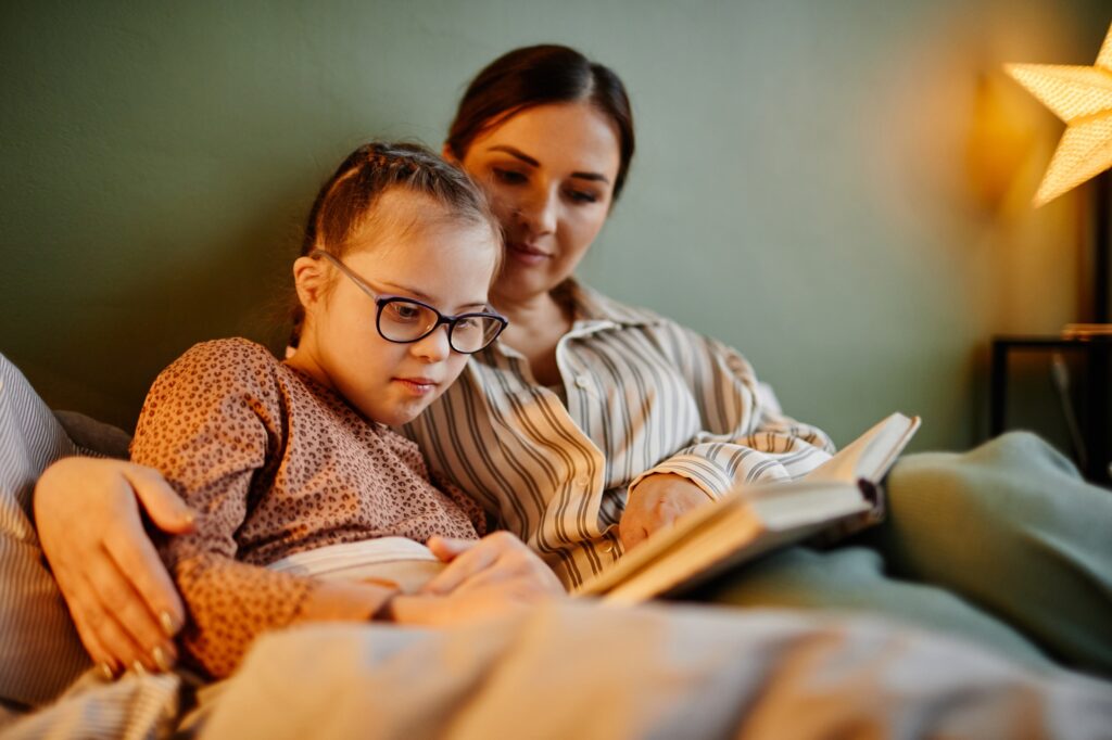 Mother and Daghter Reading Book at Night